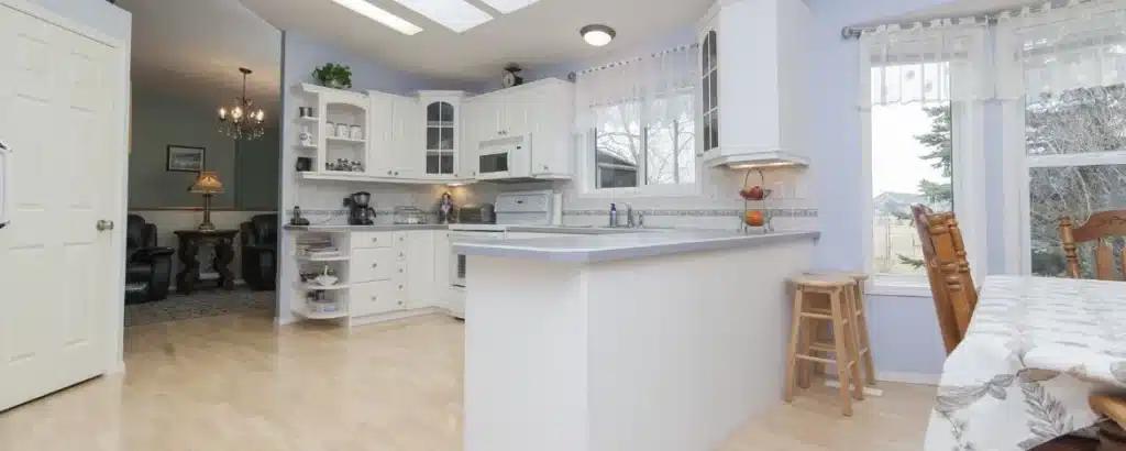 Custom Cabinets in Tampa displayed in a modern kitchen showroom with various wood finishes and hardware options